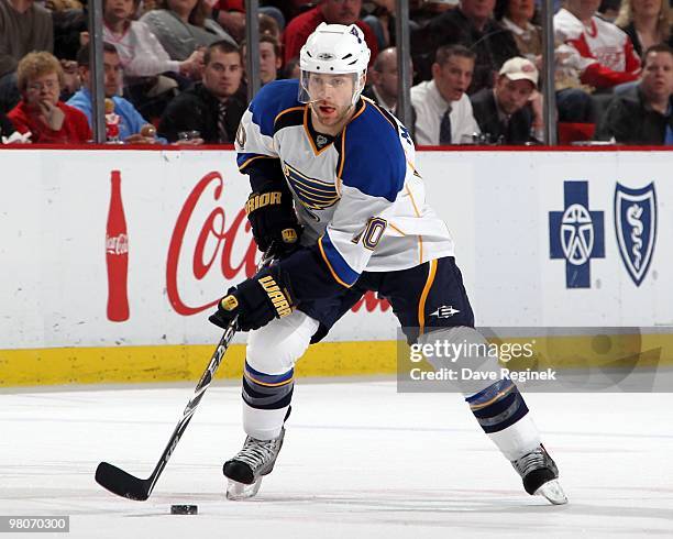 Andy McDonald of the St. Louis Blues skates with the puck during an NHL game against the Detroit Red Wings at Joe Louis Arena on March 24, 2010 in...