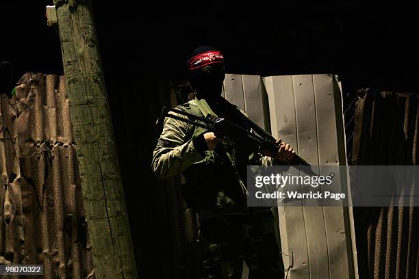 Democratic Front for the Liberation of Palestine militant poses for a photograph while on post early Friday morning, March 26, 2010 in Zeyton, Gaza...