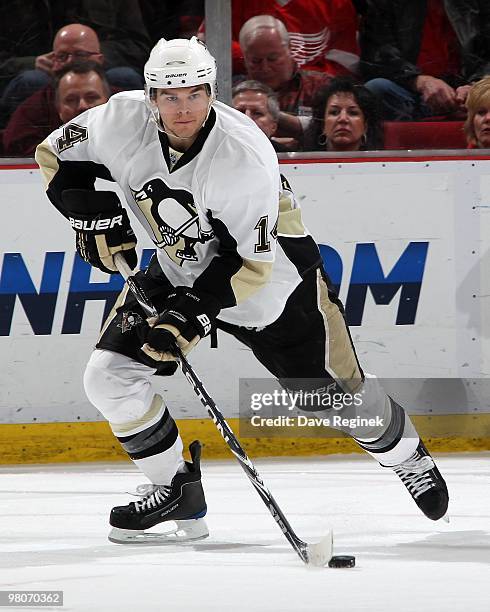 Chris Kunitz of the Pittsburgh Penguins skates with the puck during an NHL game against the Detroit Red Wings at Joe Louis Arena on March 22, 2010 in...