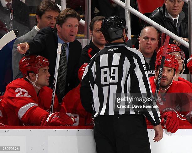 Head Coach Mike Babcock of the Detroit Red Wings talks intently with linesman Steve Miller during an NHL game against the Pittsburgh Penguins at Joe...