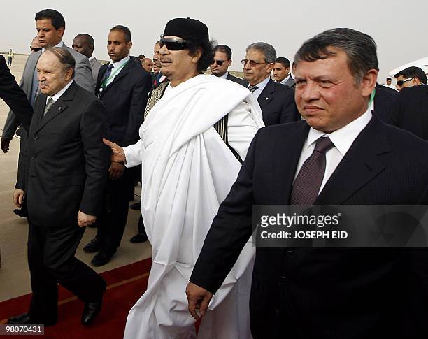 Libyan leader Moamer Kadhafi greets Jordan's King Abdullah II and Algerian President Abdelaziz Bouteflika upon their arrival at the airport in the...