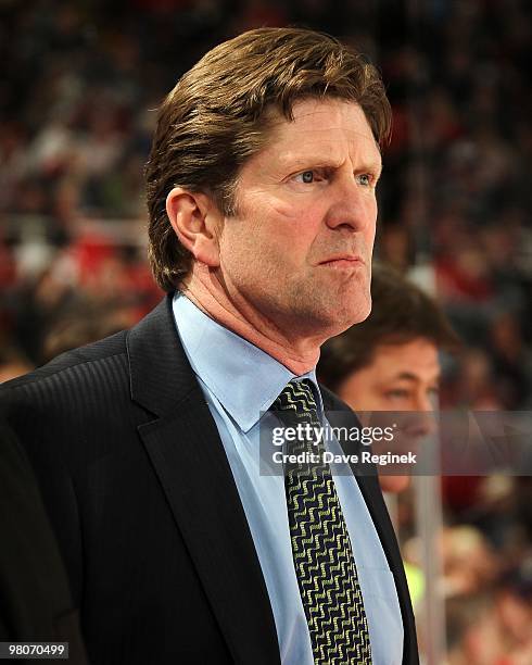 Head Coach Mike Babcock of the Detroit Red Wings watches the play from the bench during an NHL game against the Pittsburgh Penguins at Joe Louis...