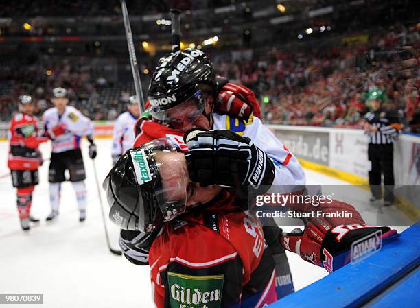 Mo Mueller of Cologne has a fight with Ryan Prestin of Ingolstadt during the DEL playoff match between Koelner Haie and ERC Ingolstadt on March 26,...