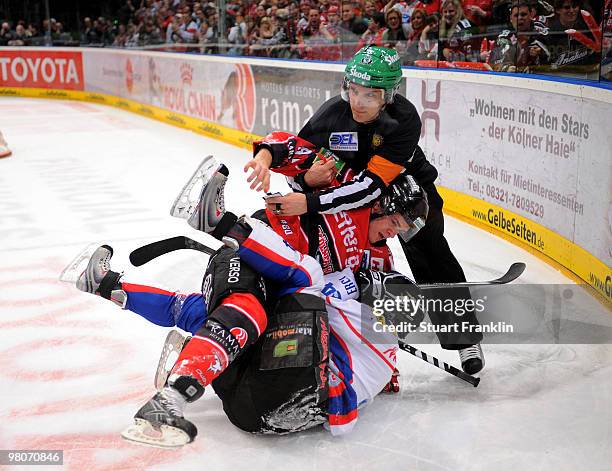 Mo Mueller of Cologne has a fight with Ryan Prestin of Ingolstadt during the DEL playoff match between Koelner Haie and ERC Ingolstadt on March 26,...
