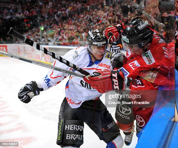 Mo Mueller of Cologne has a fight with Ryan Prestin of Ingolstadt during the DEL playoff match between Koelner Haie and ERC Ingolstadt on March 26,...