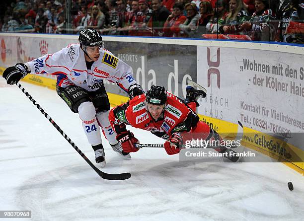 Daniel Rudslatt of Cologne challenges for the puck with Ryan Prestin of Ingolstadt during the DEL playoff match between Koelner Haie and ERC...