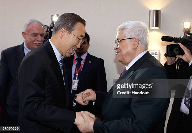 In this handout image supplied by the Palestinian Press Office , Palestinian President Mahmoud Abbas greets UN Secretary General Ban Ki-Moon in Sirte...
