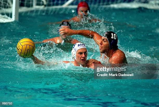 Craig Miller of Australia and Aleksandar Sapic of Yugoslavia in action during the Men's Water Polo Quarter Final match played between Australia and...