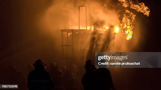 firefighters helped stop the fire . fire in the industrial factory. - emergency response stock pictures, royalty-free photos & images