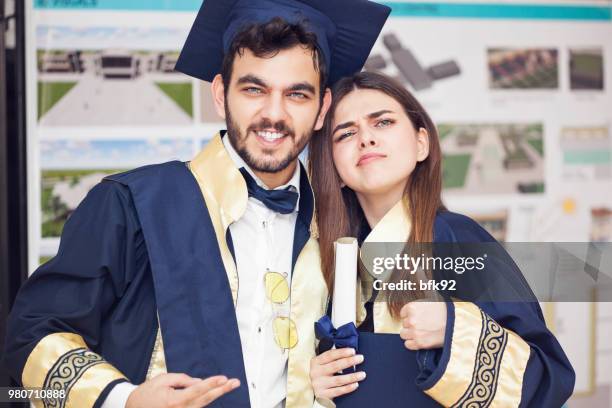 graduation - portrait of two happy graduating students. - class of 92 stock pictures, royalty-free photos & images