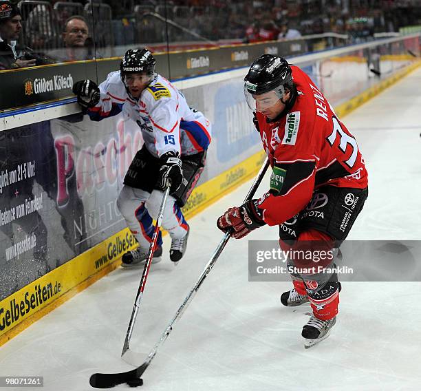 Andreas Renz of Cologne fights for the puck with Pat Kavanagh of Ingolstadt during the DEL playoff match between Koelner Haie and ERC Ingolstadt on...