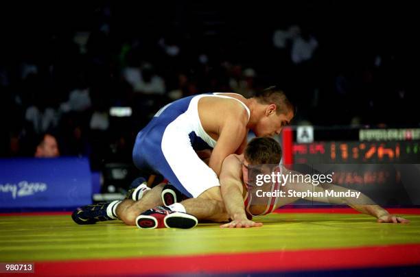 Nepes Gukulov of Turkmenistan Brett Cash of Australia in action during the Men's 58kg Greco Roman Wrestling held at the Sydney Convention Centre...