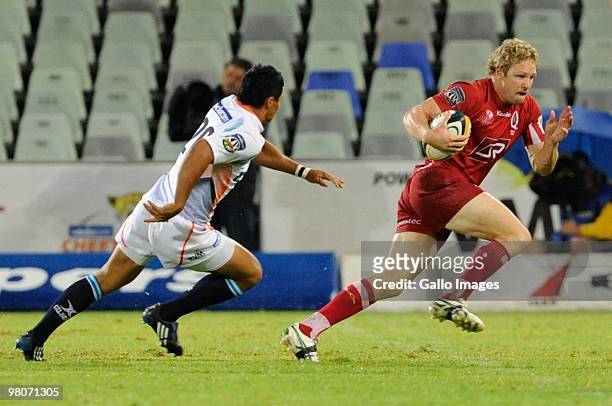 Peter Hynes of the Reds and Tewis de Bruyn of the Cheetahs in action during the Super 14 match between Vodacom Cheetahs and Reds from Vodacom Park on...