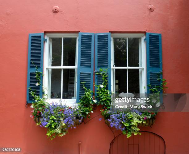 red wall with windows, charleston, south carolina, usa - flower boxes stock pictures, royalty-free photos & images