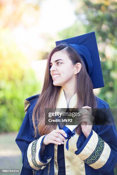 young woman celebrates graduation. - class of 92 stock pictures, royalty-free photos & images