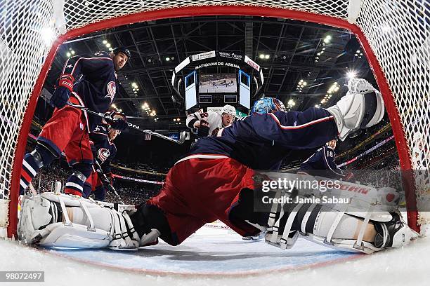 Goaltender Steve Mason of the Columbus Blue Jackets can't stop a shot by Tomas Kopecky of the Chicago Blackhawks as defenseman Fedor Tyutin of the...