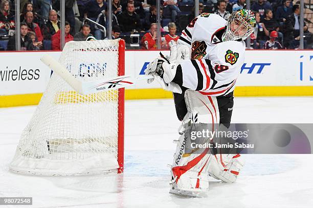 Goaltender Cristobal Huet of the Chicago Blackhawks clears the puck against the Columbus Blue Jackets on March 25, 2010 at Nationwide Arena in...