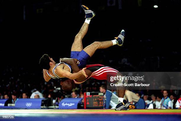 Ali Abdo of Australia and Filiberto Azcuy of Cuba in action during the Men's 69kg Greco Roman Wrestling held at the Sydney Convention Centre during...