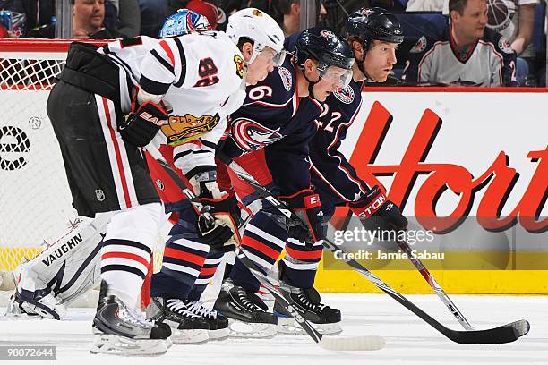 Forwards Tomas Kopecky and Samuel Pahlsson of the Columbus Blue Jackets and defenseman Mike Commodore of the Columbus Blue Jackets wait for a face...