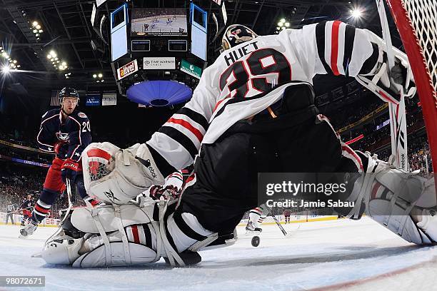 Goaltender Cristobal Huet of the Chicago Blackhawks makes a save on a shot from forward Kristian Huselius of the Columbus Blue Jackets on March 25,...