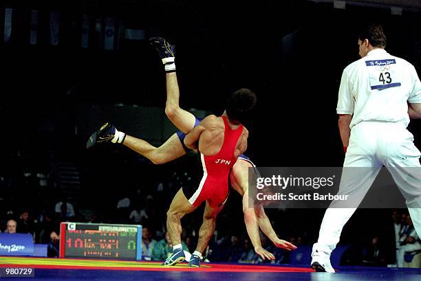 Brett Cash of Australia and Makoto Sasamoto of Japan in action during the Men's 58kg Greco Roman Wrestling held at the Sydney Convention Centre...