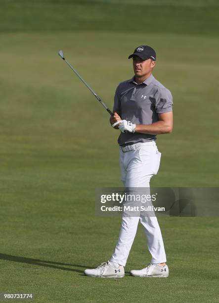 Jordan Spieth watches his second shot on the 18th hole during the first round of the Travelers Championship at TPC River Highlands on June 21, 2018...