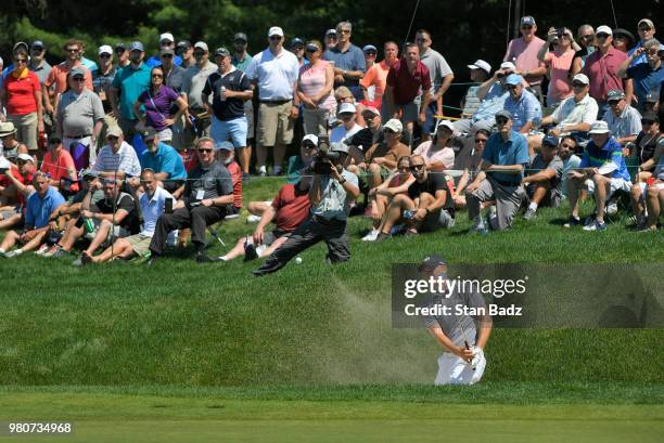 Jordan Spieth plays a bunker shot making an eagle on the sixth hole during the first round of the Travelers Championship at TPC River Highlands on...
