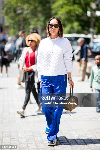 Aimee Song wearing blue pants, white jumper is seen outside Louis Vuitton on day three of Paris Fashion Week Menswear SS19 on June 21, 2018 in Paris,...