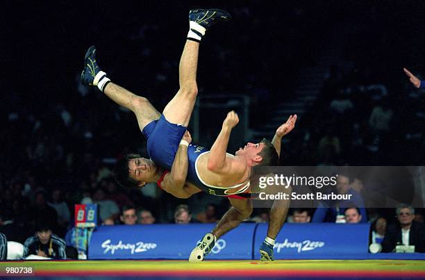 Brett Cash of Australia and Makoto Sasamoto of Japan in action during the Men's 58kg Greco Roman Wrestling held at the Sydney Convention Centre...