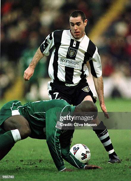 Damien Francis of Wimbledon falls at the feet of Andy Hughes during the AXA sponsored FA Cup third round match between Notts County and Wimbledon at...