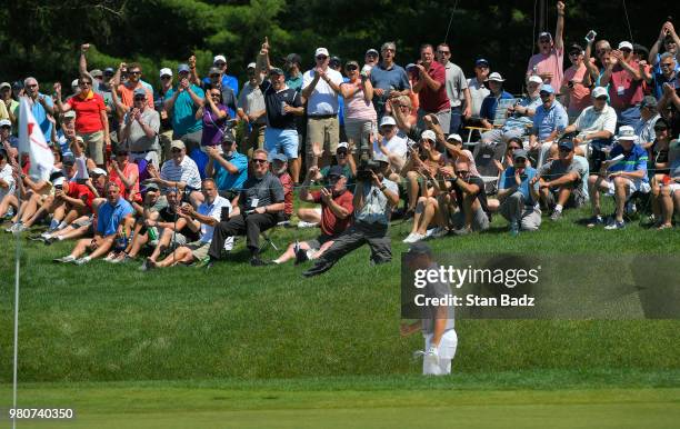 Fans celebrate Jordan Spieth's eagle from a bunker on the sixth hole during the first round of the Travelers Championship at TPC River Highlands on...