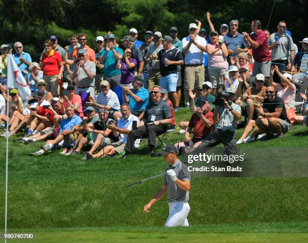 Fans celebrate Jordan Spieth's eagle from a bunker on the sixth hole during the first round of the Travelers Championship at TPC River Highlands on...