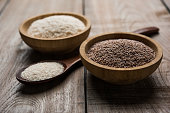 Psyllium husk or isabgol which is fiber derived from the seeds of Plantago ovata, mainly found in India. Served in a bowl over moody background. selective focus