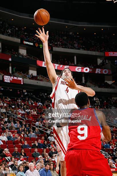 Luis Scola of the Houston Rockets shoots against Andre Iguodala of the Philadelphia 76ers during the game on February 6, 2010 at the Toyota Center in...