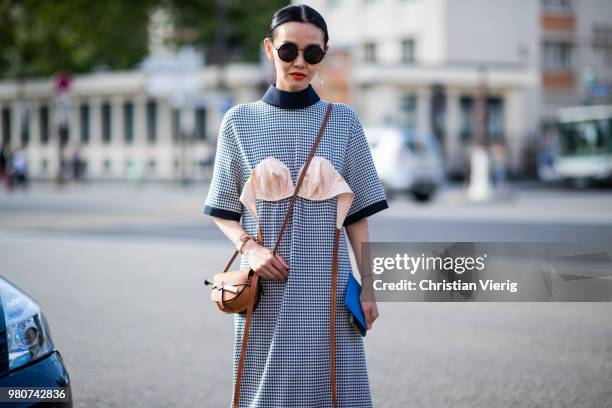 Sherry Shen wearing Loewe bag, dress with bra is seen outside Dries Van Noten on day three of Paris Fashion Week Menswear SS19 on June 21, 2018 in...