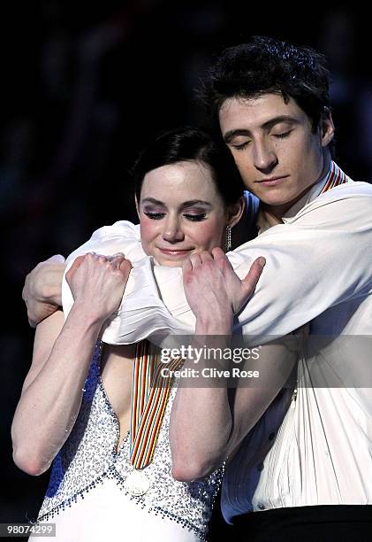 Tessa Virtue and Scott Moir of Canada cuddle on the podium with their Gold medals after the Ice Dance Free Dance during the 2010 ISU World Figure...