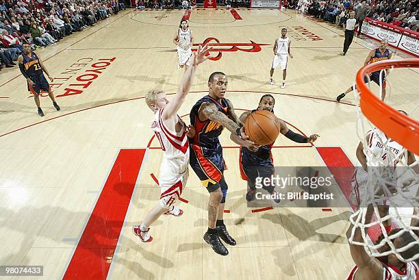 Monta Ellis of the Golden State Warriors takes the ball to the basket against Chase Budinger of the Houston Rockets during the game on February 2,...