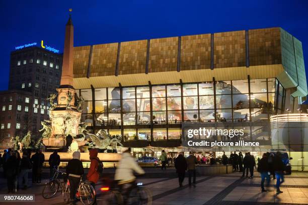 March 2018, Germany, Leipzig: The Gewandhaus concert hall and the Mende Fountain are illuminated in the evening. The lettering '275 Jahre Gewandhaus...