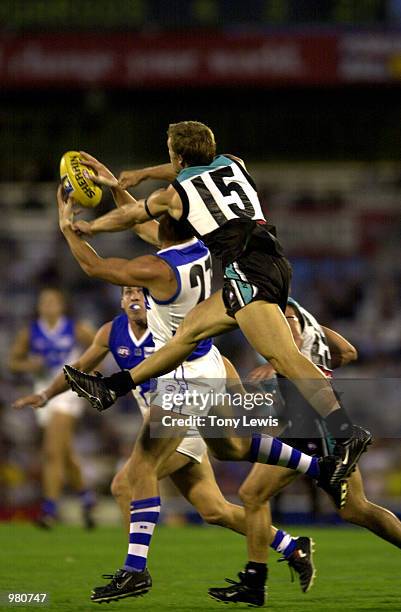 Adam Lange for the Kangaroos marks despite Michael Wilson for Port Adelaide's attempt to spoil in the Ansett Cup semi-final match between Port Power...