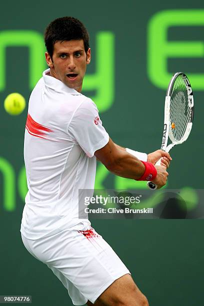 Novak Djokovic of Serbia returns a shot against Olivier Rochus of Germany during day four of the 2010 Sony Ericsson Open at Crandon Park Tennis...