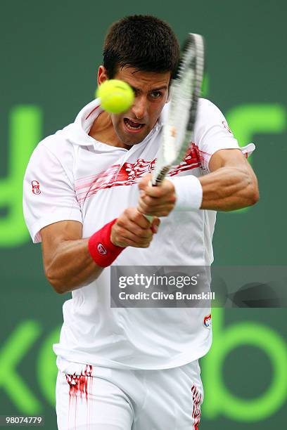 Novak Djokovic of Serbia returns a shot against Olivier Rochus of Germany during day four of the 2010 Sony Ericsson Open at Crandon Park Tennis...