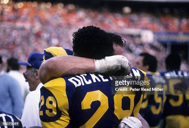 Rear view of Los Angeles Rams Eric Dickerson victorious, hugging teammate after setting single season rushing record during game vs Houston Oilers....