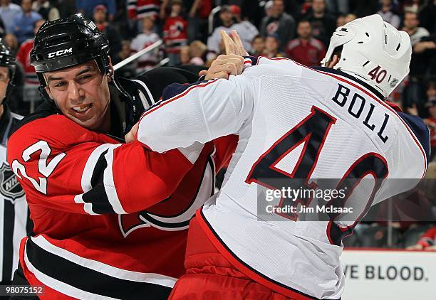 Jared Boll of the Columbus Blue Jackets trades punches with Pierre-Luc Letourneau-Leblond of the New Jersey Devils during their second period fight...