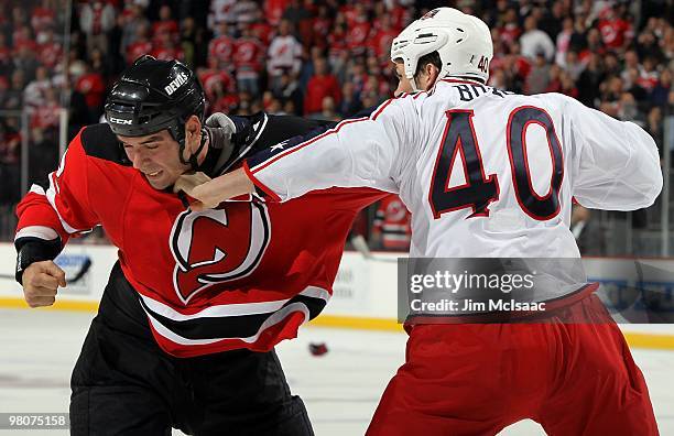 Jared Boll of the Columbus Blue Jackets trades punches with Pierre-Luc Letourneau-Leblond of the New Jersey Devils during their second period fight...