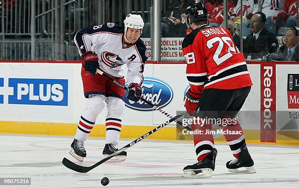 Umberger of the Columbus Blue Jackets skates against Martin Skoula of the New Jersey Devils at the Prudential Center on March 23, 2010 in Newark, New...