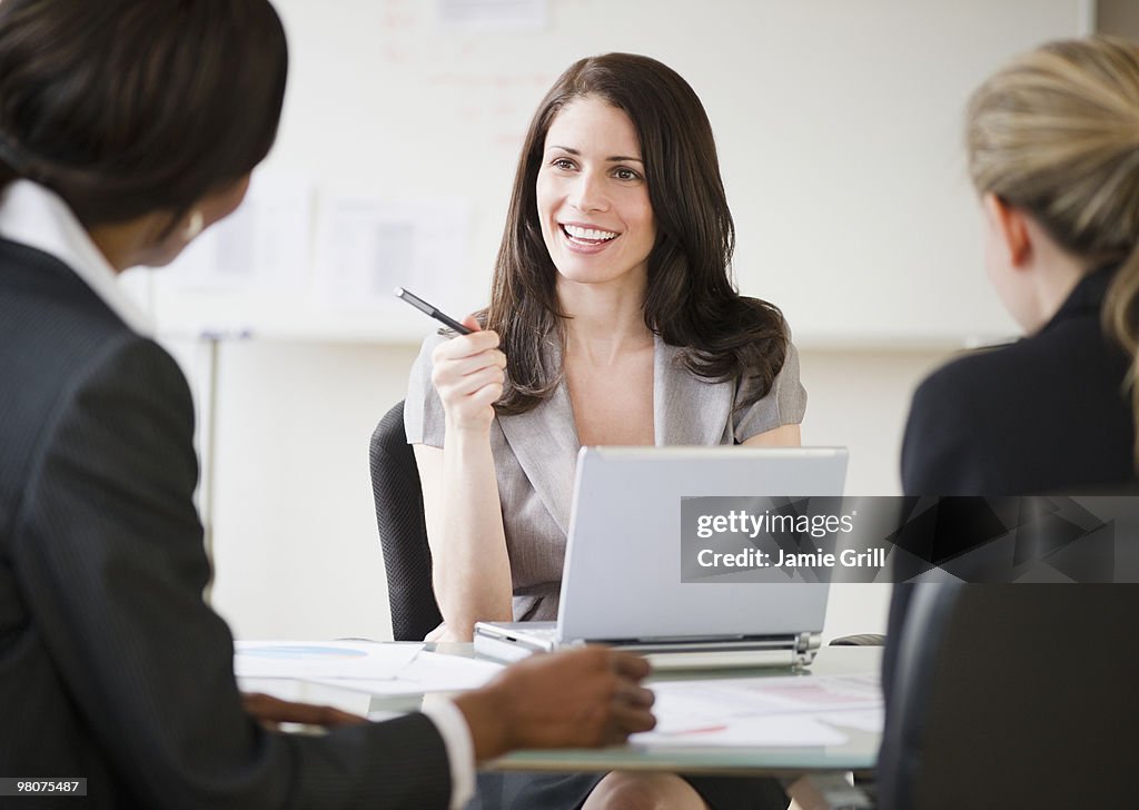 Businesswoman presenting to group, smiling