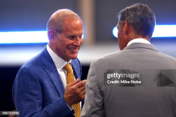 Head coach John Beilein of the Michigan Wolverines speaks to head coach of Jay Wright of the Villanova Wildcats during the 2018 NBA Draft at the...