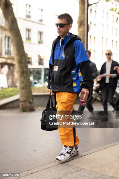 Guest is seen on the street during Paris Men's Fashion Week S/S 2019 wearing a blue/black ski jacket with orange pants on June 21, 2018 in Paris,...