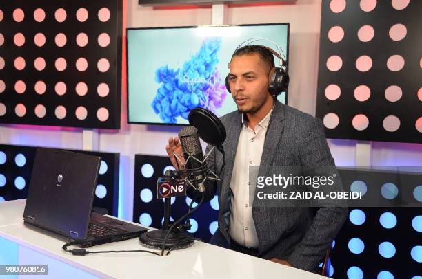 Radio presenter Ahmad al-Jaffal broadcasts his programme on One FM, a radio station in the northern Iraqi city of Mosul, on May 30, 2018. - During...