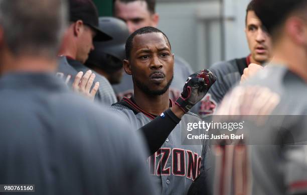 Jarrod Dyson of the Arizona Diamondbacks is greeted by teammates in the dugout after coming around to score on an RBI double by Jon Jay in the second...